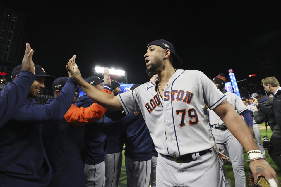 Houston Astros' Jose Abreu (79) greets teammates after the team defeated the Minnesota Twins in Game 4 to win a baseball AL Division Series, Wednesday, Oct. 11, 2023, in Minneapolis. (AP Photo/Stacy Bengs)