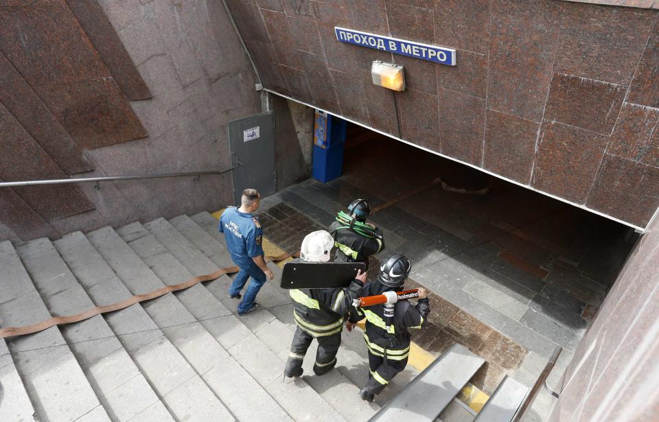 Members of the emergency services enter a metro station following an accident on the subway in Moscow July 15, 2014. Two people were killed when a train on the Moscow subway went off the rails between two stations on Tuesday, and up to 45 were injured, an emergency services official said. (REUTERS/Sergei Karpukhin)