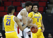 N.C. State's Jericole Hellems (4) fights for a rebound between Pittsburgh's Terrell Brown (21) and Pittsburgh's Justin Champagnie (11) during the first half of an NCAA college basketball game in Raleigh, N.C., Sunday, Feb. 28, 2021. (Ethan Hyman/The News & Observer via AP)