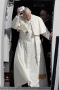 Pope Francis holds his cap as he disembarks off a plane upon his arrival at Dublin international airport, Ireland, Saturday, Aug. 25, 2018. Pope Francis is on a two-day visit to Ireland. (AP Photo/Greorio Borgia)