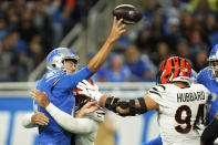 Detroit Lions quarterback Jared Goff is pressured by Cincinnati Bengals defensive end Trey Hendrickson during the first half of an NFL football game, Sunday, Oct. 17, 2021, in Detroit. (AP Photo/Paul Sancya)