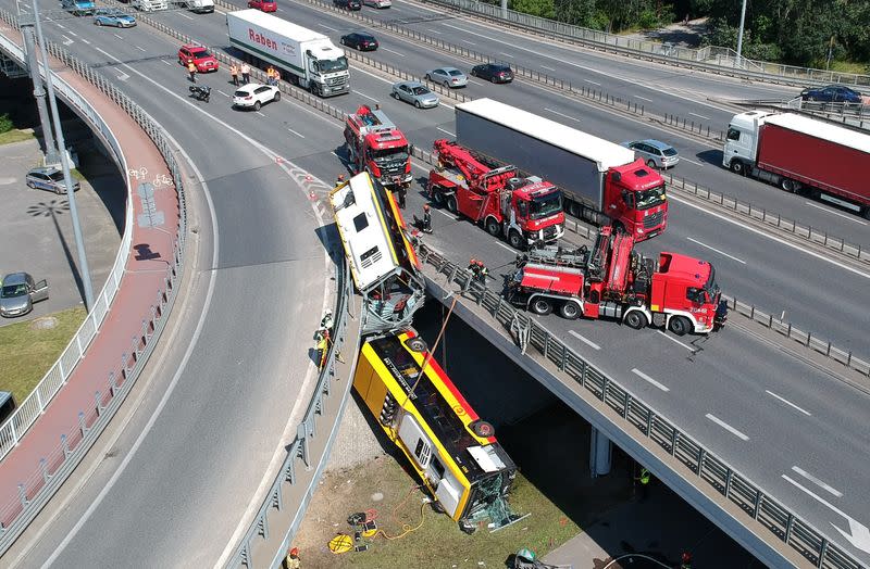 First responders attend to the scene of a public bus crash in Warsaw