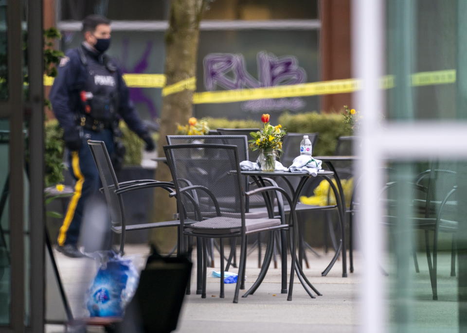 Members of the police are seen outside of the Lynn Valley Library, in North Vancouver, British Columbia, Saturday, March 27, 2021. Police say multiple victims were stabbed inside and outside the library today. (Jonathan Hayward/The Canadian Press via AP)