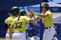 Australia's Chelsea Forkin (25) celebrates with teammates after scoring in the eighth inning of a softball game against United States at the 2020 Summer Olympics, Sunday, July 25, 2021, in Yokohama, Japan. (AP Photo/Sue Ogrocki)