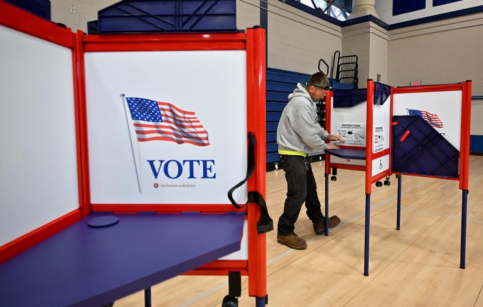 In a file photo, Parks Department foreman Mark Rainey sets up voting booths at Worcester Technical High School.