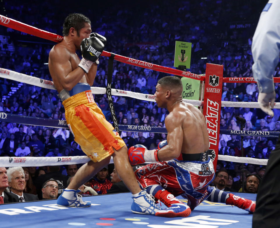 Michael Farenas, from the Philippines, left, sends Yuriorkis Gamboa, from Miami, Fla., to the canvas in the ninth round during their WBA interim super featherweight title fight Saturday, Dec. 8, 2012, in Las Vegas. (AP Photo/Eric Jamison)