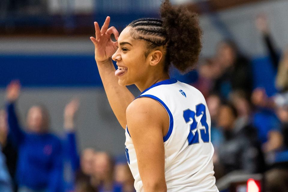 Marian's Shayla Alexander (23) celebrates a 3-point shot during the Marian vs. Saint Joseph girls sectional championship basketball game Saturday, Feb. 4, 2023 at Marian High School.