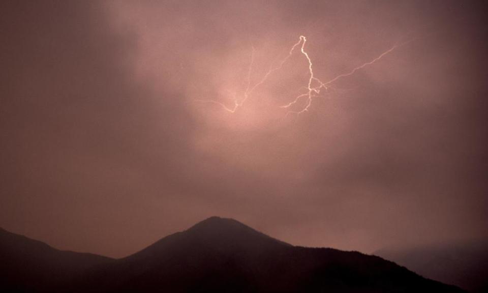 Lightning flashes over Siskiyou county, California, last month. Lightning strikes sparked new wildfires for crews battling the McKinney fire nearby.