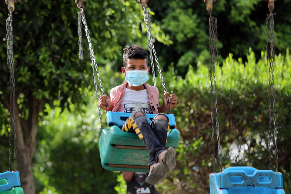 BAGHDAD, May 27, 2020  -- An Iraqi boy wearing a face mask plays on a swing in Baghdad, Iraq, on May 27, 2020. Iraqi Health Ministry on Wednesday said that a total of 5,135 COVID-19 cases were confirmed since the outbreak of the disease in the country, of whom up to 175 have died. (Xinhua via Getty) (Xinhua/ via Getty Images)