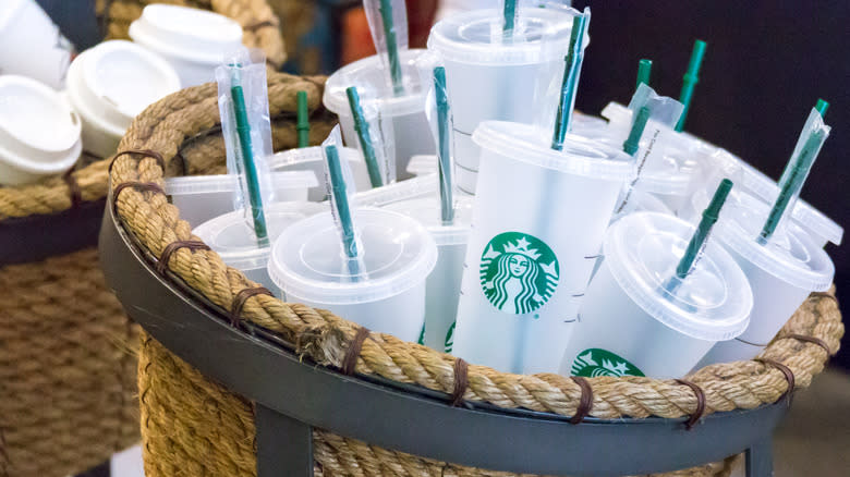 basket of reusable Starbucks cups