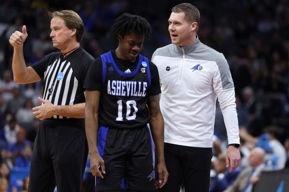UNC Asheville coach talks to Alex Caldwell during the second half of Thursday's NCAA loss to UCLA.