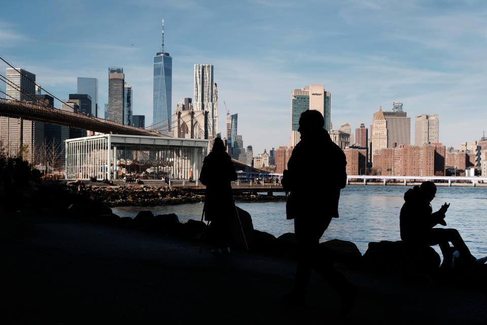 FTSE NEW YORK, NEW YORK - DECEMBER 05: People walk by the Manhattan skyline in Brooklyn on December 05, 2022 in New York City. For the first time ever New York City has been named as the most expensive city in the world by the Economist Intelligence Unit annual survey and will share the title with Singapore. The city rose to the top spot due to rising rents and other factors. Manhattan apartments jumped up by 25 percent in 2022.  (Photo by Spencer Platt/Getty Images)