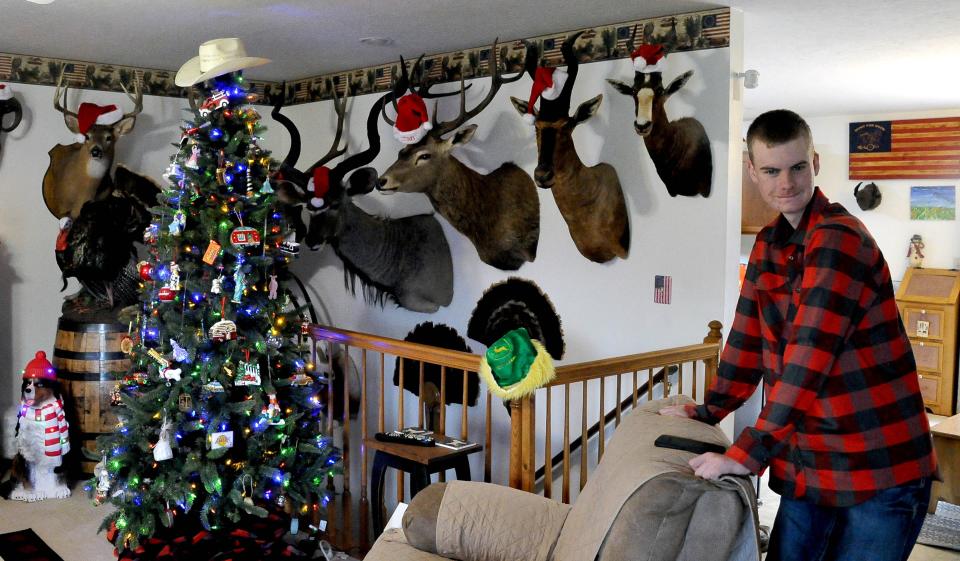 Cooper Meshew stands with some of the animals he has hunted on trips with his father Scott,