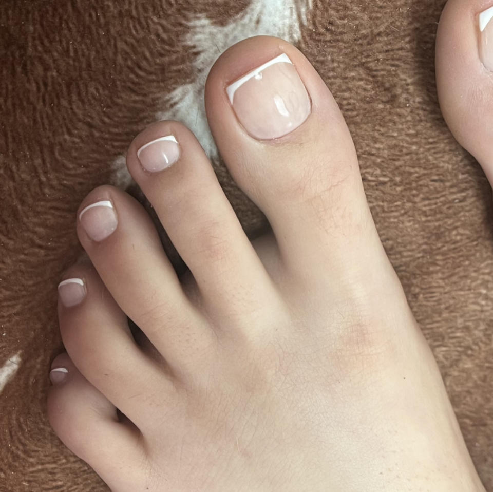 Close-up of a person's feet with neatly manicured toenails