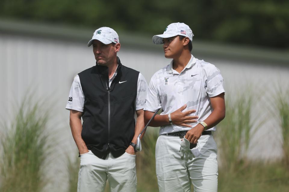 Michigan State golf coach Casey Lubahn stands with MSU freshman golfer Lorenzo Pinili during the Folds of Honor Collegiate at American Dunes Golf Club in Grand Haven, Mich.