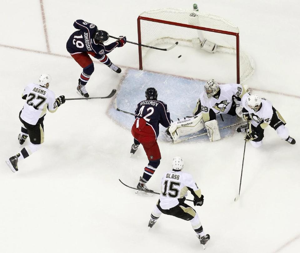 Columbus Blue Jackets' Ryan Johansen (19) scores a goal against Pittsburgh Penguins' Marc-Andre Fleury (29) as Blue Jackets' Artem Anisimov (42), of Russia, Penguins' Craig Adams (27), of Brunei, Tanner Glass (15) and Brooks Orpik (44) wait for a rebound during the second period of Game 4 of a first-round NHL playoff hockey series on Wednesday, April 23, 2014, in Columbus, Ohio. The Blue Jackets defeated the Penguins 4-3 in overtime. (AP Photo/Jay LaPrete)