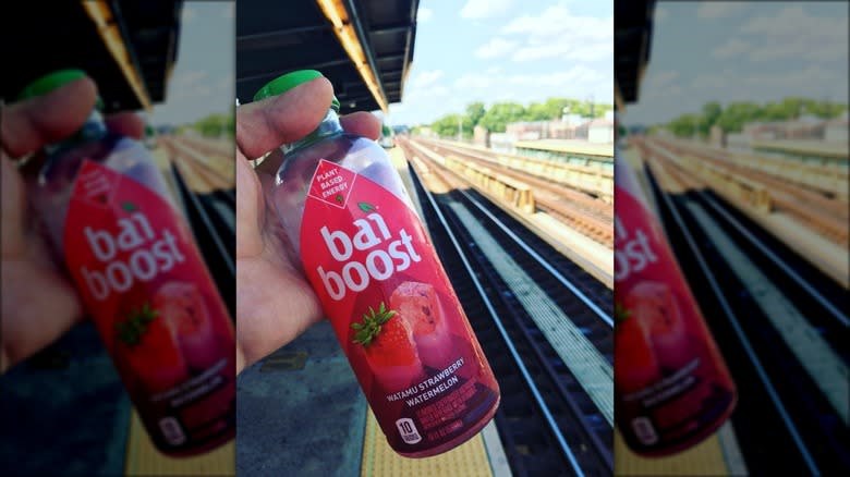 person holding Bai Boost bottle