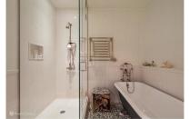 <p>The free-standing vintage claw-foot tub is free-standing and sits next to a glass-enclosed shower. Source: Streeteasy via Douglas Elliman </p>