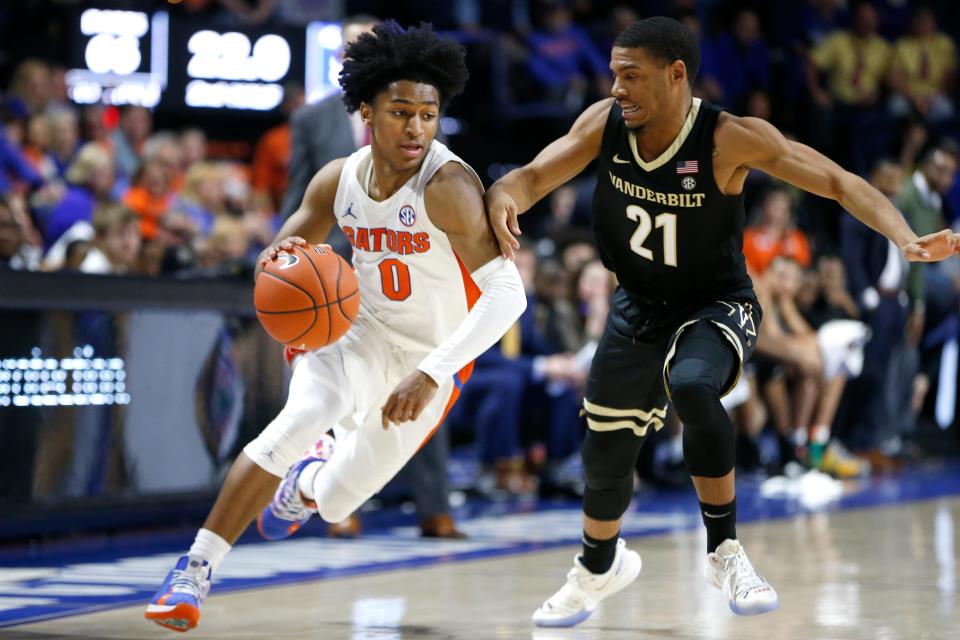 Feb 15, 2020; Gainesville, Florida, USA; Florida Gators guard Ques Glover (0) drives the ball around Vanderbilt Commodores guard Jon Jossell (21) during the second half at Exactech Arena. Mandatory Credit: Reinhold Matay-USA TODAY Sports