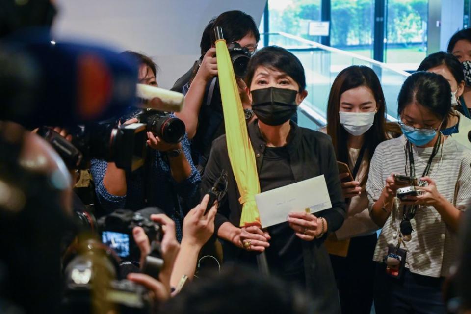 Pro-democracy lawmaker Claudia Mo holds a yellow umbrella and her resignation letter at the Legislative Council in Hong Kong on November 12, 2020, after the pro-democracy bloc said they would resign en masse in protest at the ousting of four of their colleagues by the city's pro-Beijing authorities.<span class="copyright">Photo by PETER PARKS/AFP via Getty Images</span>