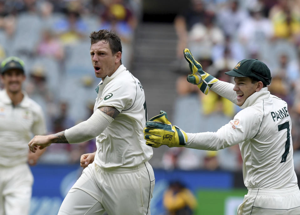 Australia's James Pattinson, left celebrates with team mate Tim Paine, right, after capturing the wicket of New Zealand's BJ Watling during a cricket test match in Melbourne, Australia, Saturday, Dec. 28, 2019. (AP Photo/Andy Brownbill)