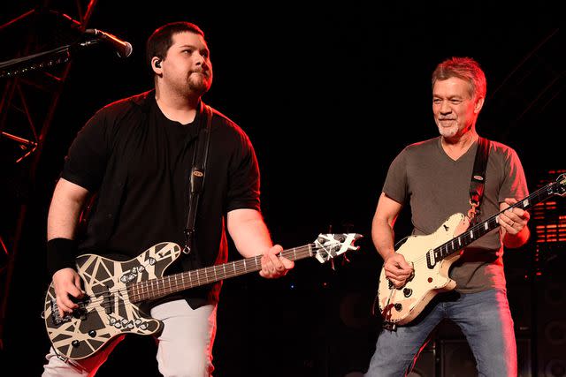 <p>Kevin Mazur/Getty</p> Wolfgang Van Halen and Eddie Van Halen perform together in New York in August 2015