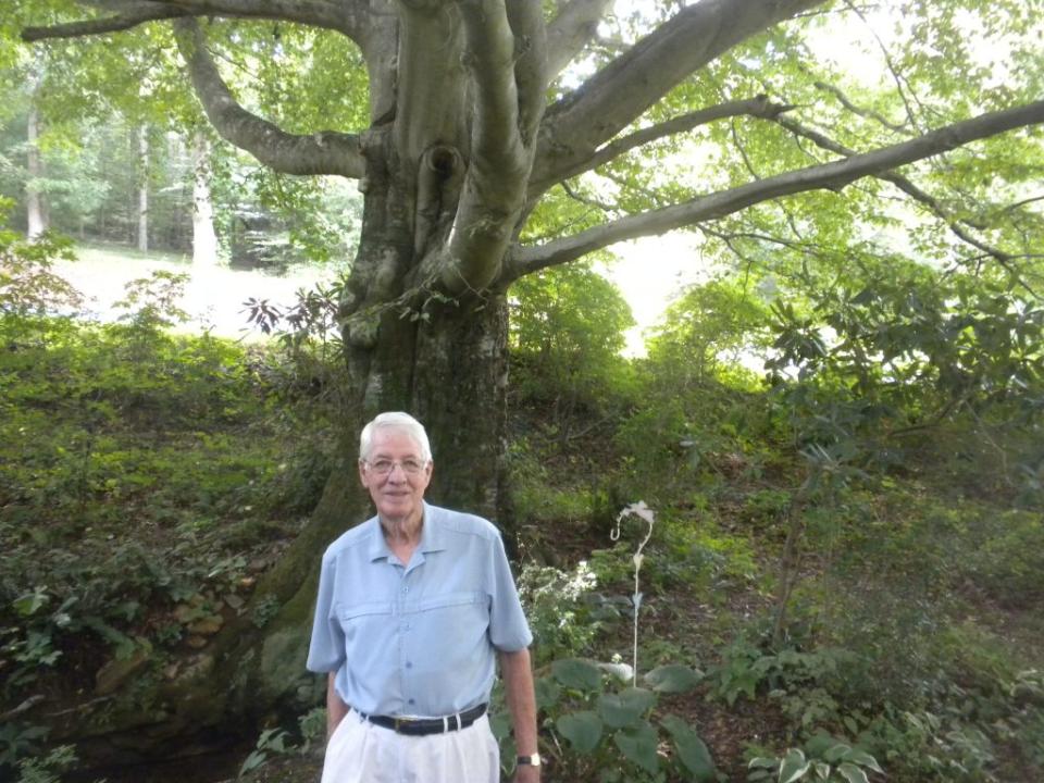 <em>The late Glen Wood and the American Beech tree that served as his team’s first engine hoist. (Photo by Mike Hembree)</em>