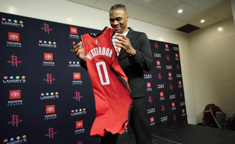 Recently acquired Houston Rockets' guard Russell Westbrook grabs his jersey after a news conference, Friday, July 26, 2019, in Houston. Westbrook was acquired from the Oklahoma City Thunder.