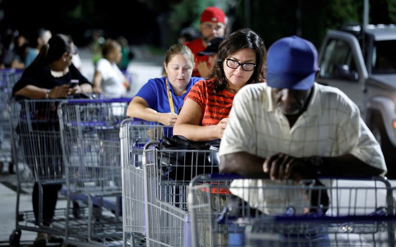 FILE PHOTO: Shoppers wait in line for supplies before sunrise ahead of the arrival of Hurricane Dorian in Kissimmee