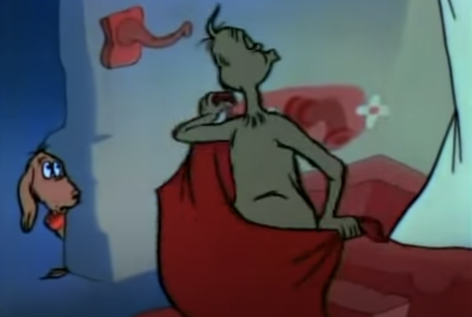 The grinch drying his back and whistling