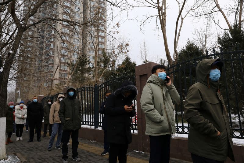 People line up for nucleic acid test outside a makeshift testing site at a residential compound, following new confirmed cases of the coronavirus disease (COVID-19), in Beijing