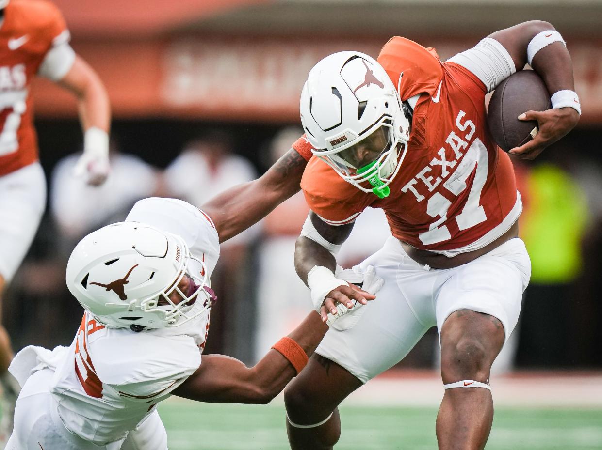 Texas running back Savion Red evades a tackle from linebacker Ty'Anthony Smith in the fourth quarter of Saturday's spring game.