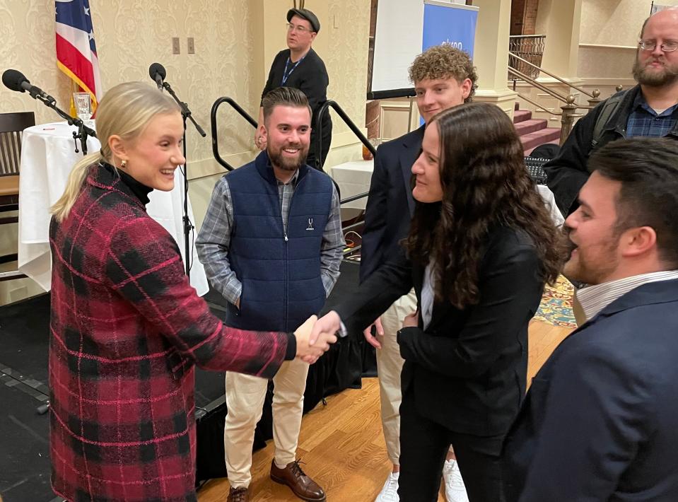 Olmsted Falls High School and Ashland University graduate Katie Moon talks to people who attended Thursday's Akron Roundtable session at Quaker Station to hear her speak about her journey to an Olympic gold medal in the pole vault.