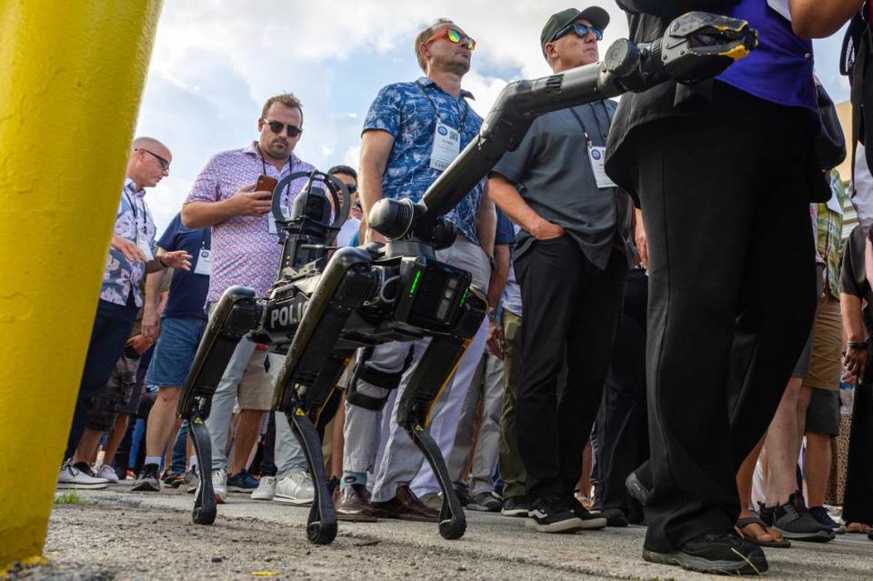 Guests followed “Spot,” a robotic dog owned by Miami-Dade Police’s Special Response Team Department to their seats during a South Florida Public Safety Regional Assets in Action Demonstration showcasing an active threat response incident in Biscayne Bay as part of the annual 2024 National Homeland Security Conference at PortMiami, Terminal J on Wednesday, July 24, 2024, in Miami, Fla.