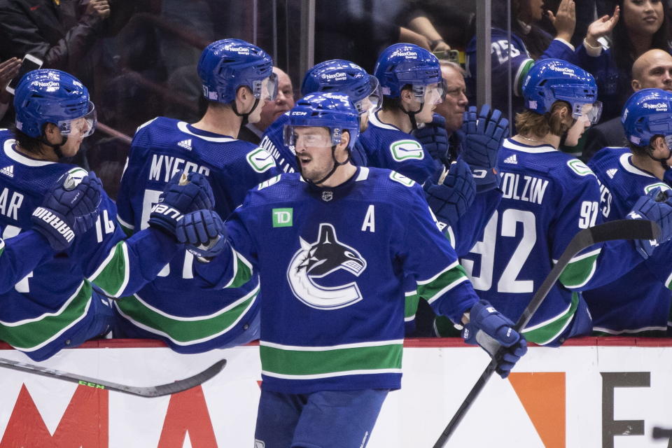 Vancouver Canucks' J.T. Miller is congratulated for his goal against the Anaheim Ducks during the second period of an NHL hockey game Thursday, Nov. 3, 2022, in Vancouver, British Columbia. (Ben Nelms/The Canadian Press via AP)