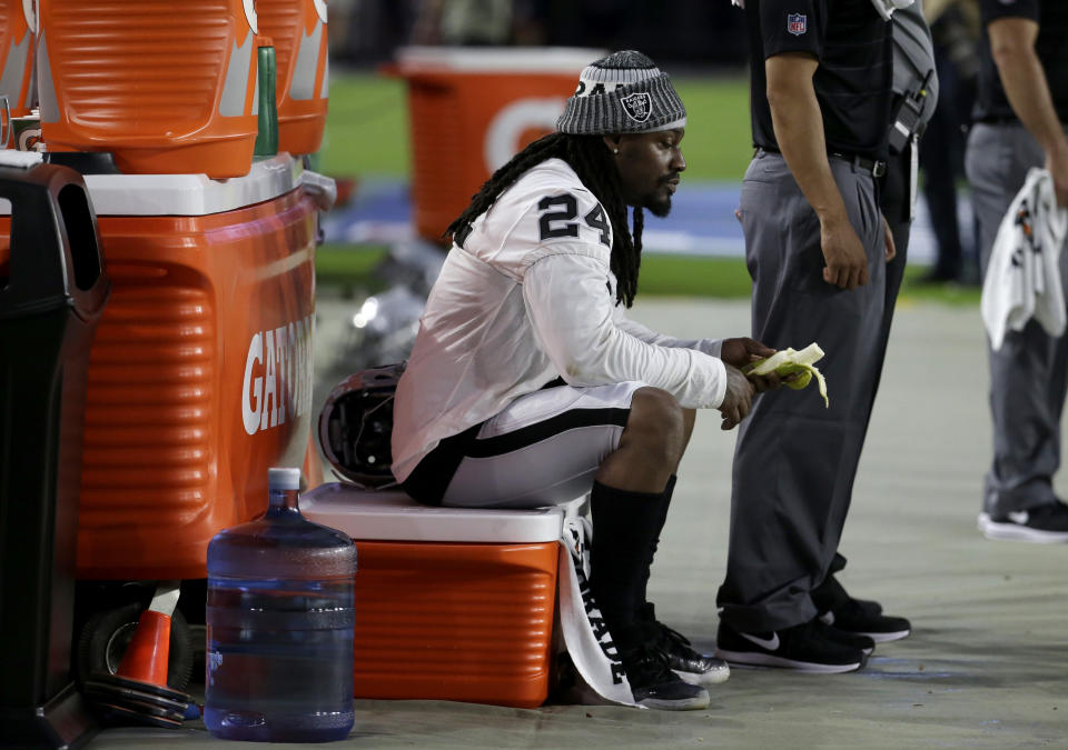 Oakland Raiders running back Marshawn Lynch (24) sits during the national anthem prior to an NFL preseason football game against the Arizona Cardinals, Saturday, Aug. 12, 2017, in Glendale, Ariz. (AP Photo/Rick Scuteri)