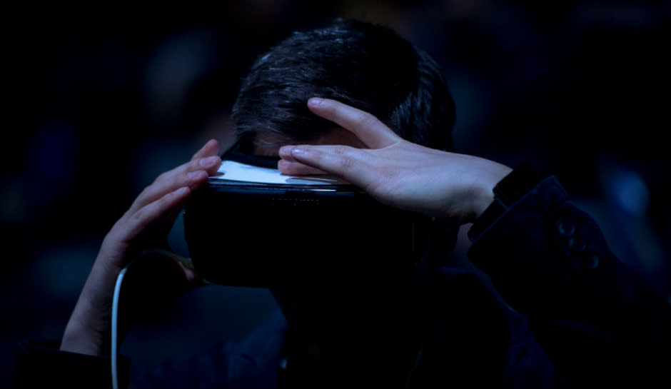 A visitor adjusts his a Samsung Gear VR device during the presentation of the new Samsung Galaxy S7 and Samsung Galaxy S7 edge