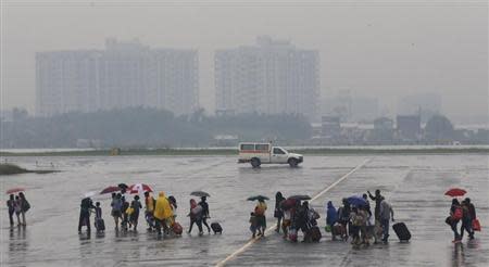 Survivors of super typhoon Haiyan arrive from Tacloban, after being flown out by the U.S. Air Force, at a Manila airport November 13, 2013. REUTERS/Wolfgang Rattay