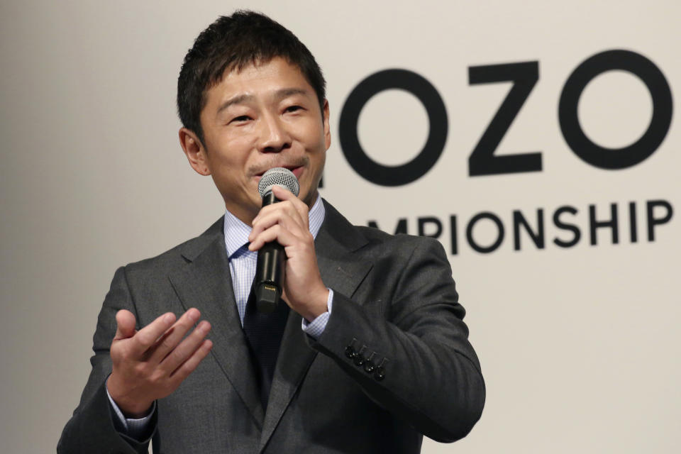 FILE - In this Nov. 20, 2018, file photo, Zozo Chief Executive Yusaku Maezawa speaks during a press conference on the PGA Tour in Tokyo. Yahoo Japan Corp. said Thursday, Sept. 12, 2019 it will put up a tender offer, estimated at 400 billion yen ($3.7 billion), for Zozo Inc., a Japanese online retailer started by a celebrity tycoon. Maezawa is known for lavish spending on artworks by Jean-Michel Basquiat, a Stradivarius violin and a future trip to the moon. (AP Photo/Koji Sasahara, File)