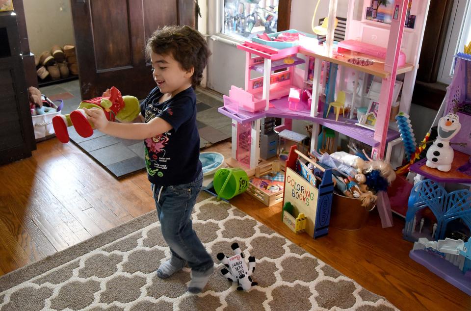 Elliott Althouse, of Monroe, who turns 5 years old today, dances to the song "You're a Mean One, Mr. Grinch," with his stuffed Christmas Grinch. Elliott will have a Grinch-themed birthday party. His family is raising awareness for Elliott's condition during November's Epilepsy Awareness Month.