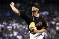 Arizona Diamondbacks pitcher Merrill Kelly throws to a Los Angeles Dodgers batter during the first inning of a baseball game Saturday, July 31, 2021, in Phoenix. (AP Photo/Rick Scuteri)