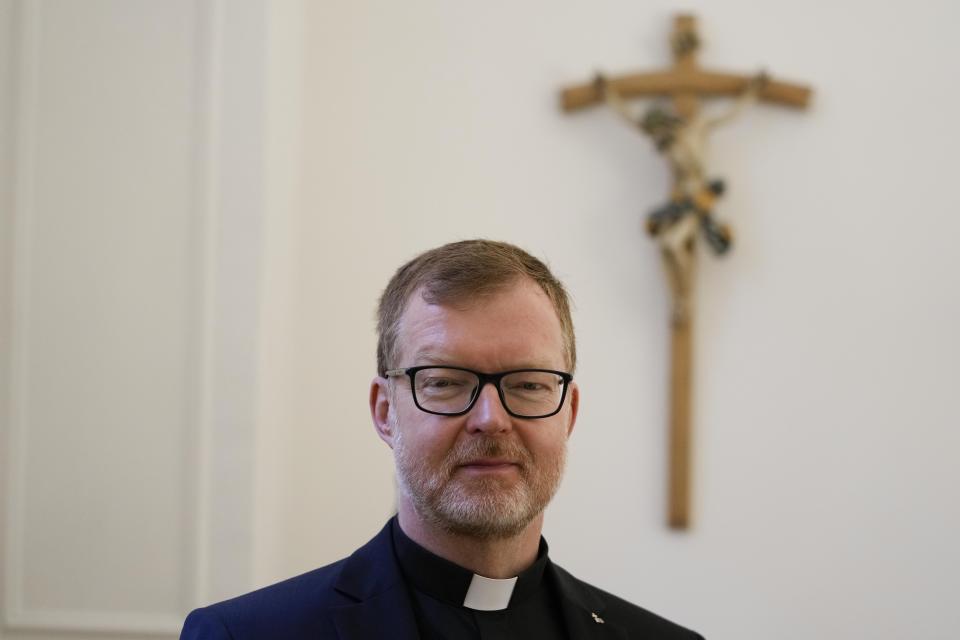 Hans Zollner, head of the new safeguarding institute at the Pontifical Gregorian University, poses for photos in his office before an interview with the Associated Press, in Rome, Wednesday, Oct. 13, 2021. The Catholic Church’s foremost research and training institute into clergy sexual abuse of minors is expanding its mandate to also include the sexual and spiritual abuse of adults, evidence that the Vatican is increasingly aware that children aren’t the only victims of clergy who abuse their power and authority. (AP Photo/Alessandra Tarantino)