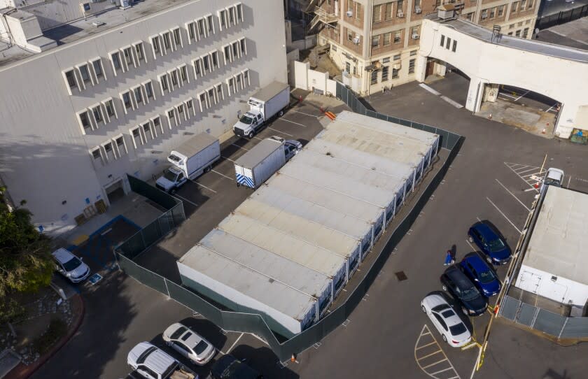 LOS ANGELES, CA - JANUARY 07: A dozen refrigerated storage containers hum in the parking lot at the Los Angeles County Coroner complex on Thursday, Jan. 7, 2021 in Los Angeles, CA. (Brian van der Brug / Los Angeles Times)