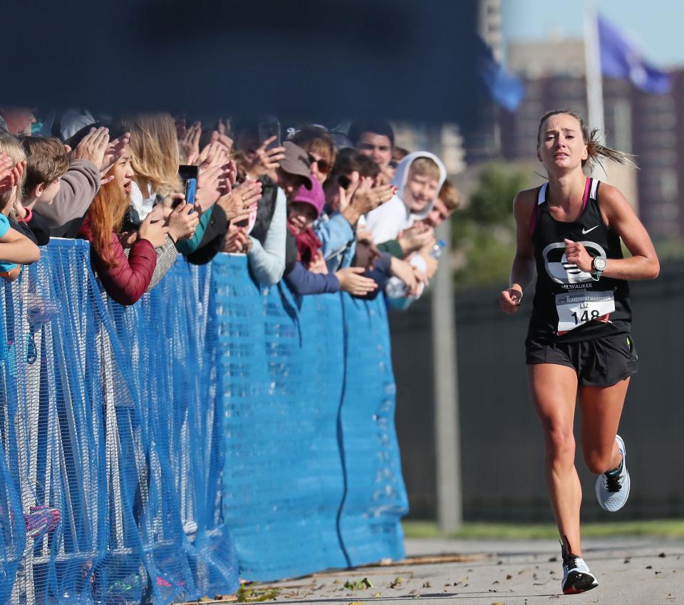 Women’s top finisher Liz Berkholtz sprints the last few yards to the finish in the 2019 Milwaukee Lakefront Marathon.