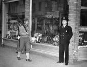 <p>This Japanese small arms and boat hardware store on Terminal Island, San Pedro, Los Angeles, Calif., on which is a large Japanese community, was closed by the U.S. customs service, Dec. 8, 1941. Pvt. Anthony Prah, left, and Lewis C. Brown, of the customs service, was detailed to guard the establishment. In Washington, Treasury Secretary Henry Morgenthau announced seizure of all Japanese banks and business enterprises in the United States. (AP Photo) </p>