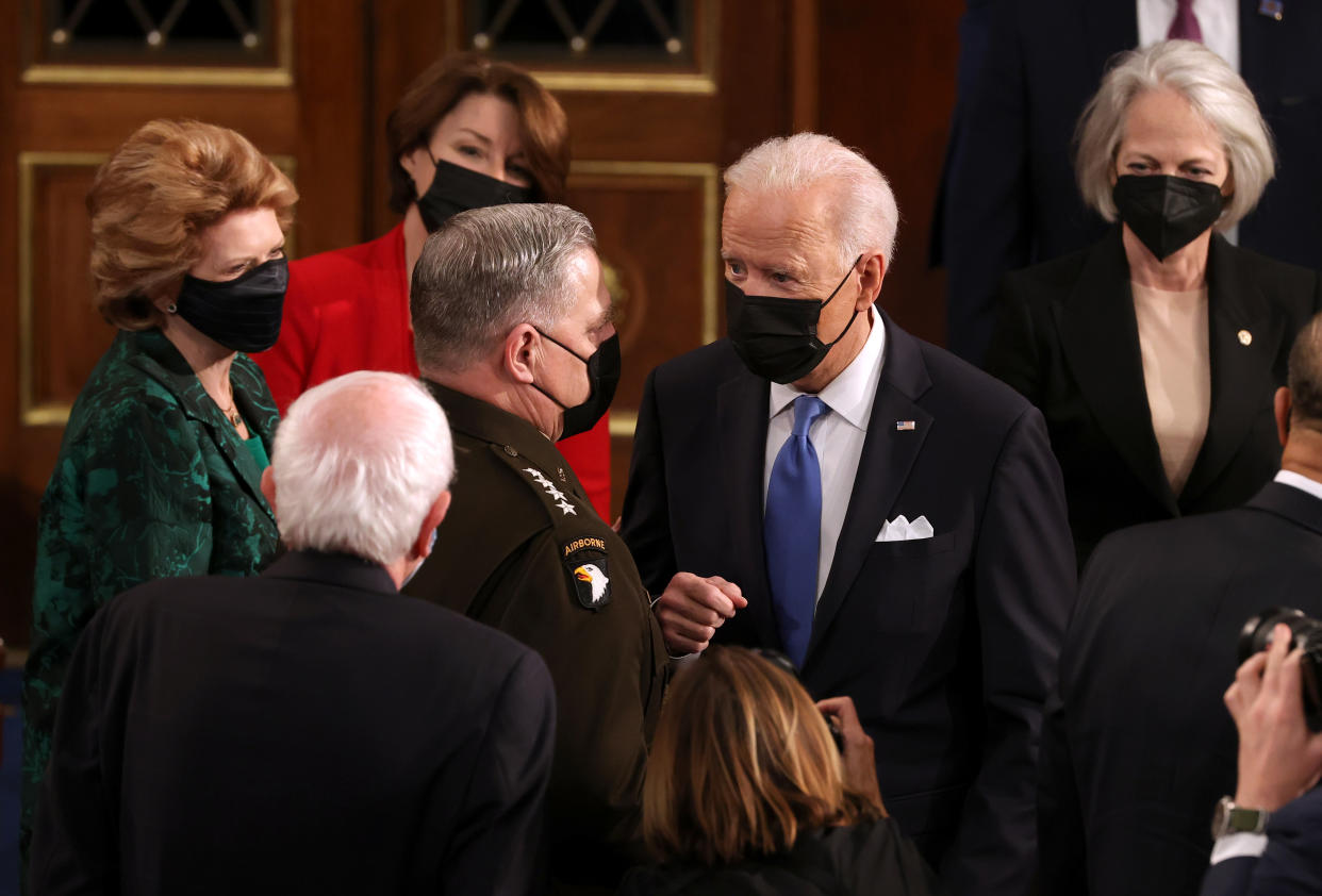 U.S. President Joe Biden speaks with Chairman of the Joint Chiefs of Staff Mark A. Milley (L) after addressing a joint session of congress in the House chamber of the U.S. Capitol April 28, 2021 in Washington, DC. (Chip Somodevilla/Getty Images)