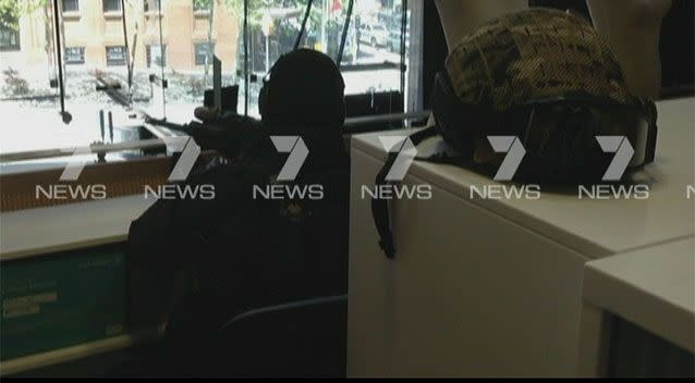 A sniper in the Seven Network newsroom, who had his sights trained on Man Haron Monis for hours. Photo: 7News