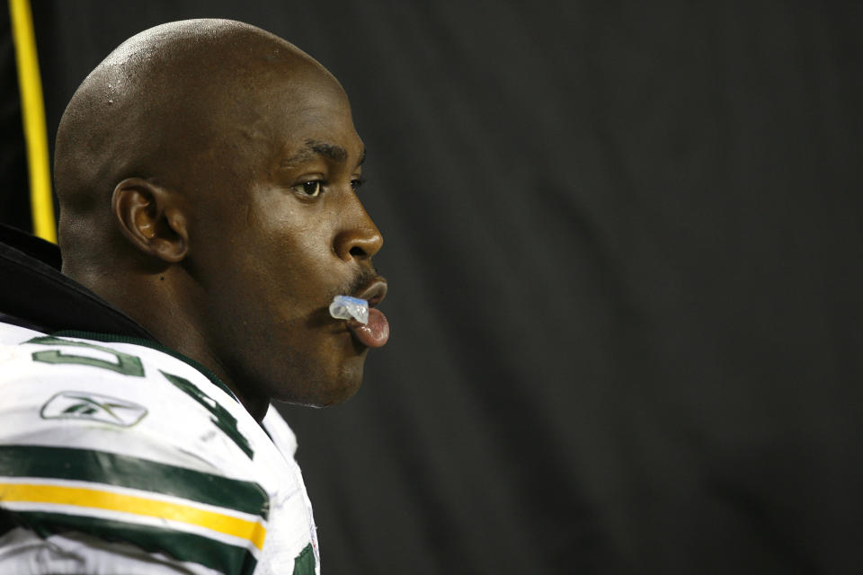 CINCINNATI - AUGUST 28:  Kabeer Gbaja-Biamila #94 of the Green Bay Packers looks on from the sideline against the Cincinnati Bengals during a preseason NFL game at Paul Brown Stadium on August 28, 2006 in Cincinnati, Ohio. The Bengals defeated the Packers 48-17. (Photo by Joe Robbins/Getty Images)