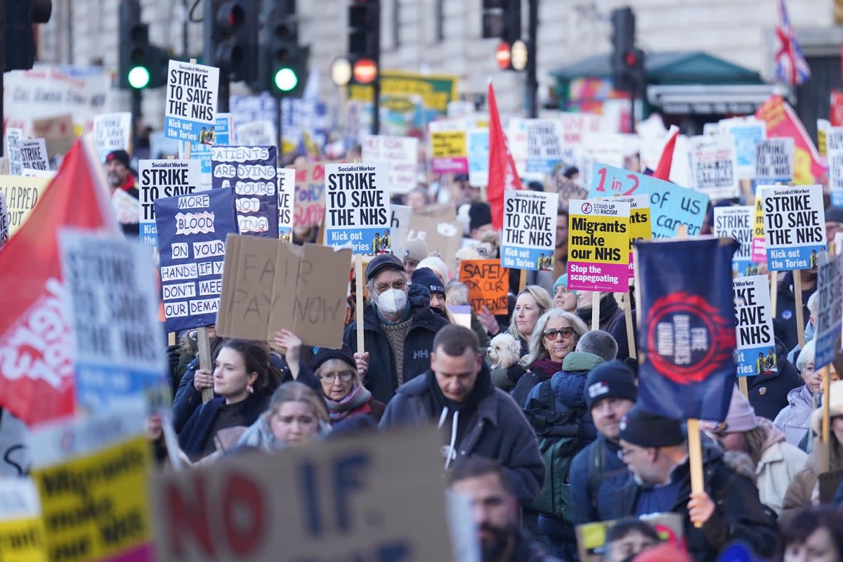 Protesters march through Trafalgar Square during the nurses’ strike (James Manning / PA)