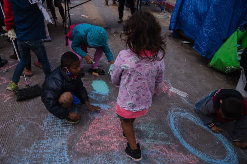 Children draw with chalk on the ground at El Chaparral plaza in Tijuana, Mexico, on March 26, 2021. File Photo by Ariana Drehsler/UPI